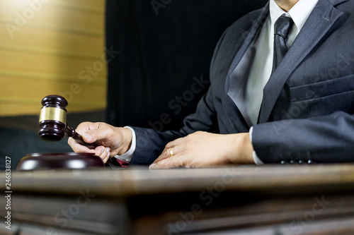 justice and law concept.Male judge in a courtroom working on wood table with documents., attorney court judge justice gavel legal legislation concept.