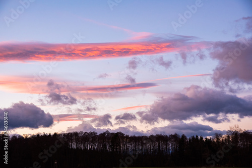 Sunset over forest with dramatic sky