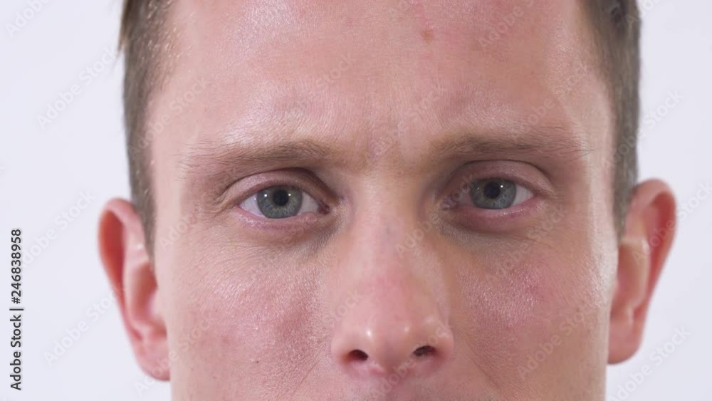 Close up face of man looking in camera isolated on a white background.