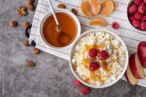 cottage cheese with fresh berries, honey, apples,  tangerines, and nuts, healthy breakfast, diet vegetarian food