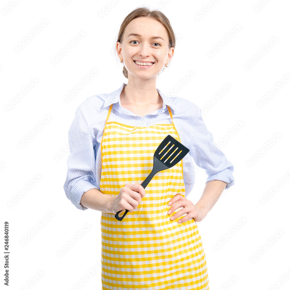 Woman in yellow apron with kitchen spatula in hand on white background isolation Woman in yellow apron with kitchen spatula in hand on white background isolation