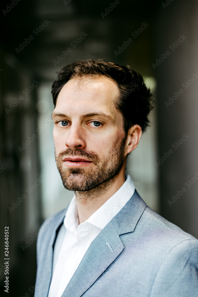 serious businessman in suit looking into camera serious businessman in suit looking into camera