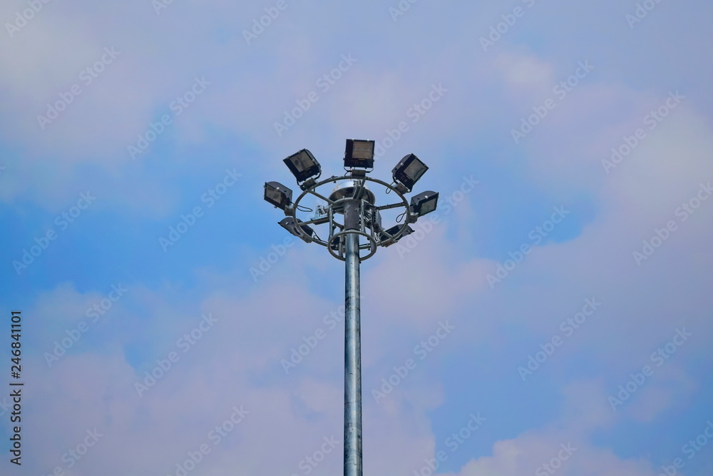 Pole mounted light bulb spotlight with a lot of background sky. Pole mounted light bulb spotlight with a lot of background sky.