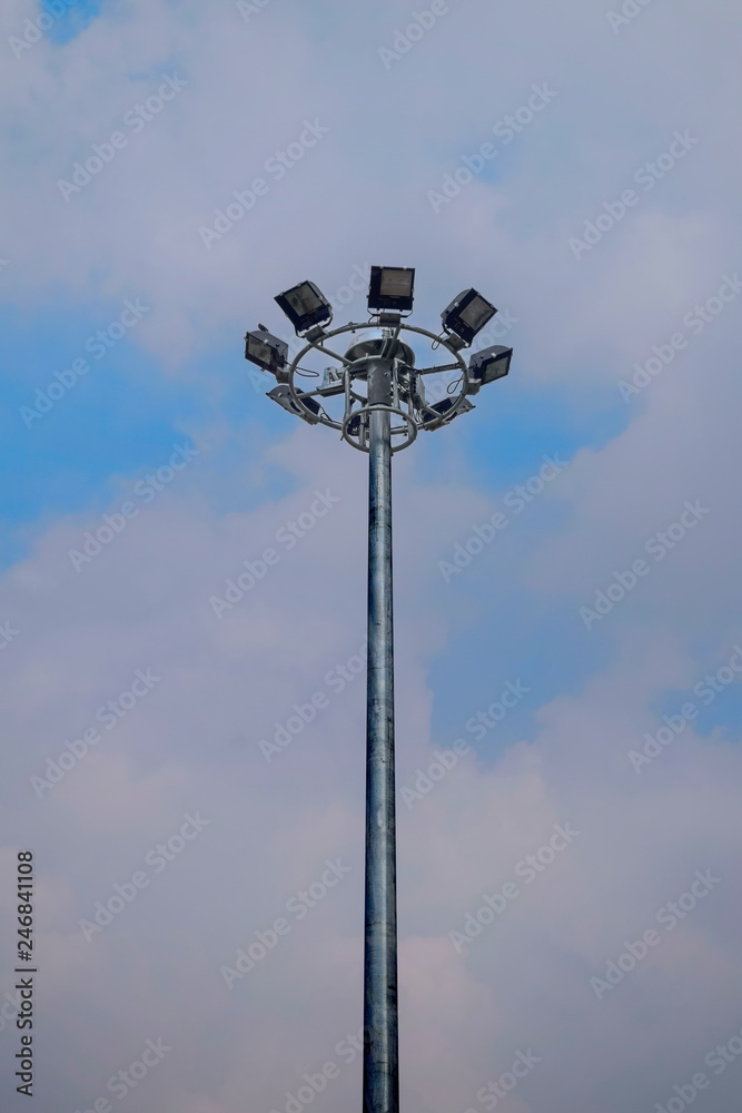 Pole mounted light bulb spotlight with a lot of background sky. Pole mounted light bulb spotlight with a lot of background sky.