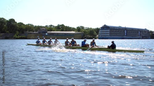 Rowing team summer training. 8 athletes rowers in a boat in the river Dnipro. City area in Kiev, Ukraine