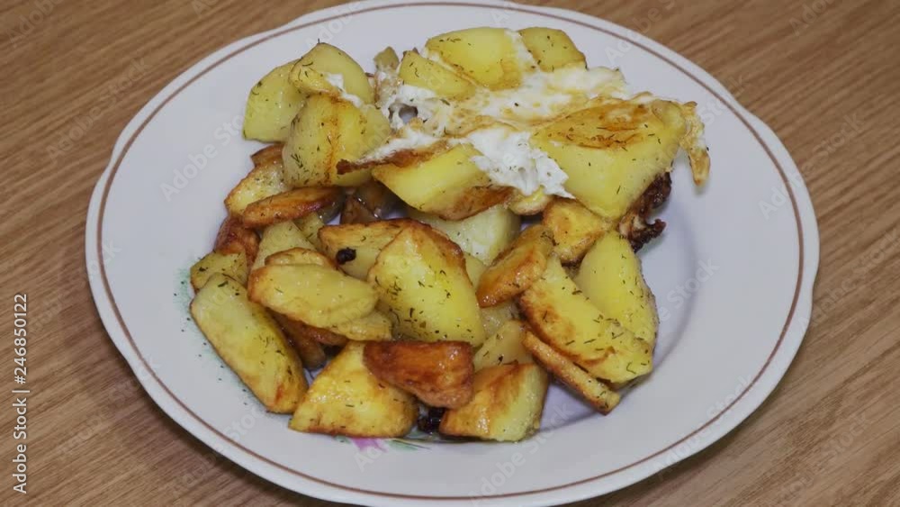 Delicious fried potatoes with bread on a plate Delicious fried potatoes with bread on a plate