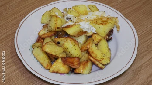 Delicious fried potatoes with bread on a plate