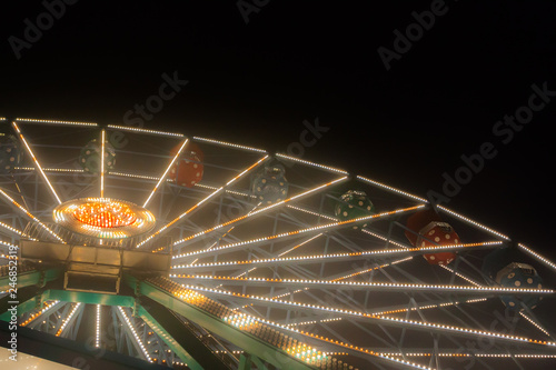 Ferris wheel at the amusement park, night illumination photo