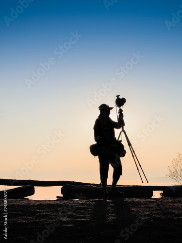view Silhouette a photographer standing with camera on tripod, sunrise at Doi Samur Dao, Sri Nan National Park, Nan, northern of Thailand. 