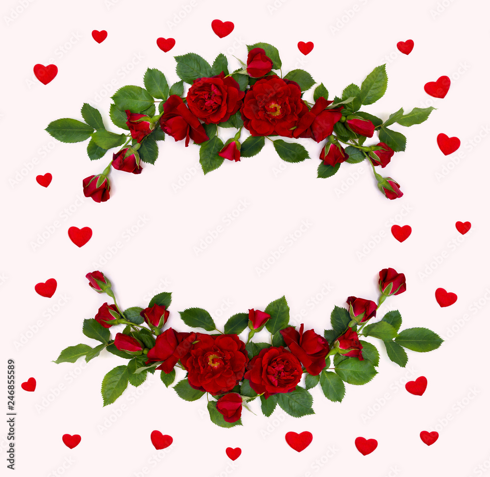 Decoration of Valentine Day. Frame of beautiful red roses and buds on pink background with hearts and space for text. Top view, flat lay Decoration of Valentine Day. Frame of beautiful red roses and buds on pink background with hearts and space for text. Top view, flat lay