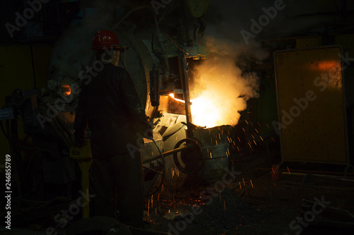 Worker of foundry production. The burning metal