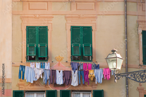 colorful old facade with dry clothes in small village Camogli