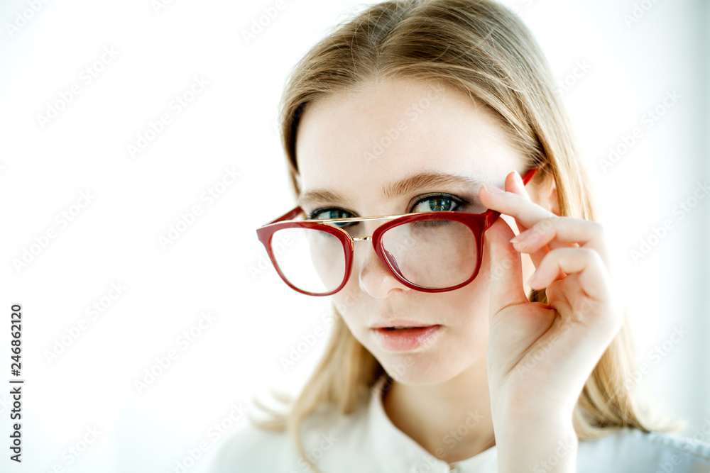 glasses with a red frame on a young model glasses with a red frame on a young model