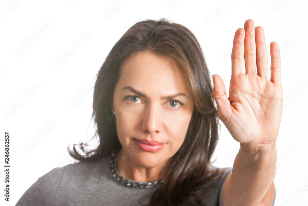 Woman with outstretched hand showing stop gesture isolated on white background Woman with outstretched hand showing stop gesture isolated on white background