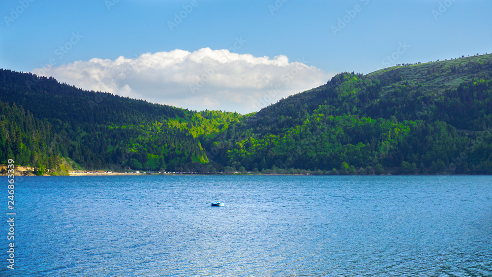 View of Abant Lake (Abant Golu). Landscape of an mountain lake in front of mountain range.  Glorious lake landscape. The collaboration of blue and green. Multiple colors and amazing lake scenery. 