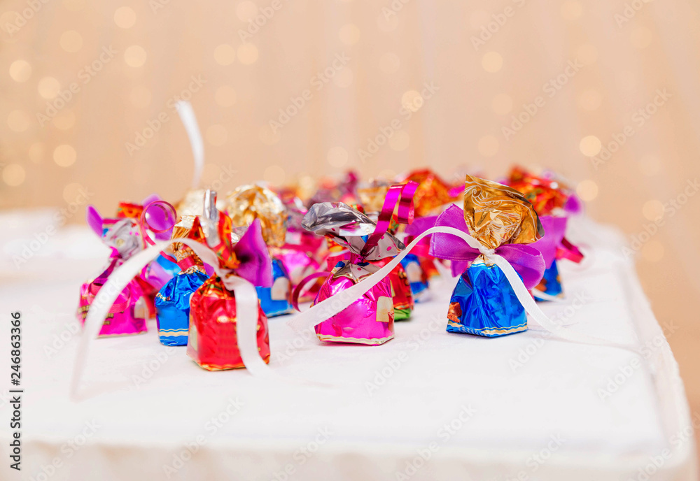 Fototapeta premium sweets on the table on a background of shiny lights