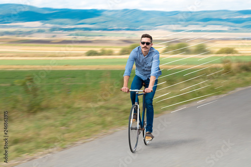 Casual hipster cyclist riding bicycle with high speed concept