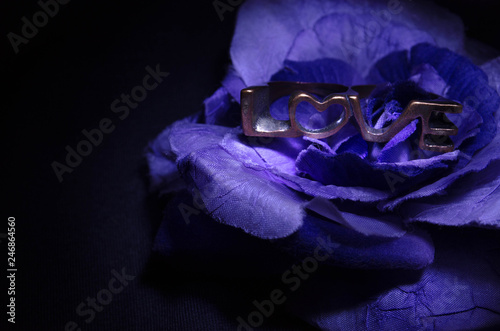 the word love on top of a flower