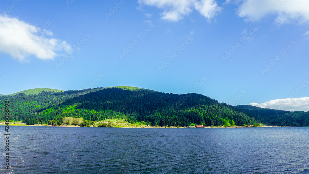 View of Abant Lake (Abant Golu). Landscape of an mountain lake in front of mountain range.  Glorious lake landscape. The collaboration of blue and green. Multiple colors and amazing lake scenery. 