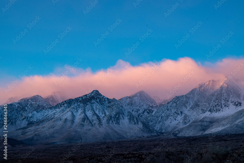 Plakat colorful cloudy morning sunrise sky over snowy mountain peaks of Sierra nevadas, California