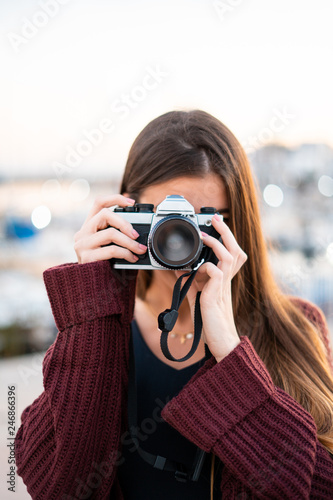 Pretty woman taking photos with retro camera © ManuPadilla