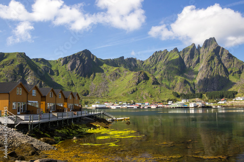colorful houses and harbor at the foot of the mountains in Lofoten
