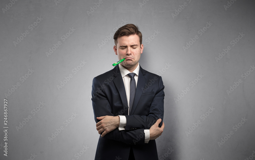 Young tired businessman with thermometer and copy space
Young tired businessman with thermometer and copy space