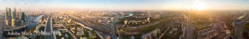 Fototapeta Naklejka Na Ścianę i Meble -  panorama high-rise buildings and transport of metropolis, traffic and blurry lights of cars on multi-lane highways and road junction at sunset in Moscow.