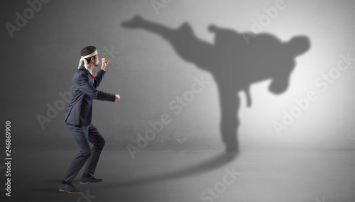 Businessman fighting with his strong karate man shadow   © ra2 studio