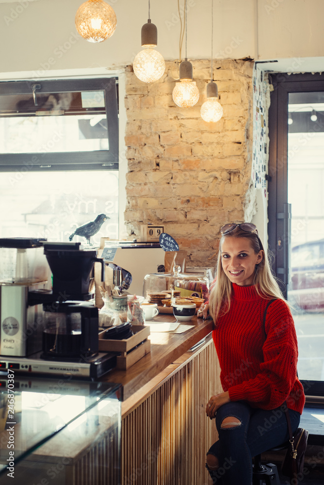 Happy woman enjoying some coffee in a cafeteria Happy woman enjoying some coffee in a cafeteria