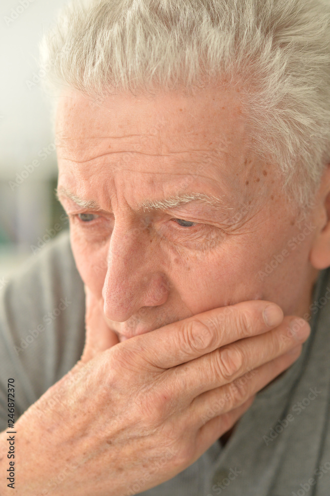 portrait of thoughtful senior man at home portrait of thoughtful senior man at home