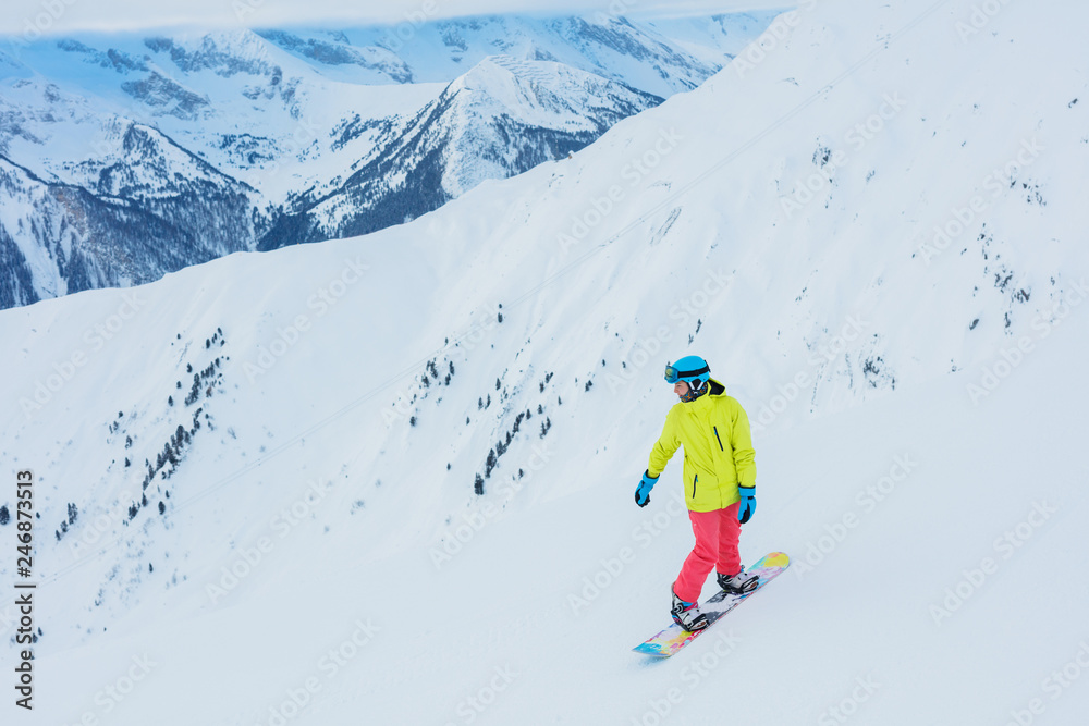 Girl snowboarder having fun in the winter ski resort.