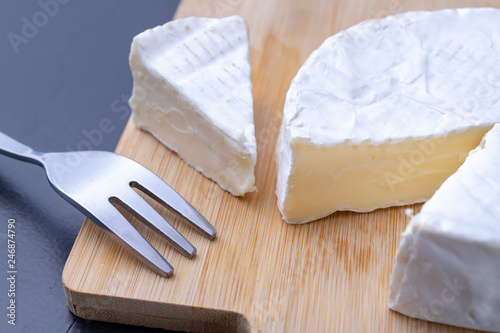 Tasty blue cheese on a wooden board. Prepared Italian dishes on the kitchen table.