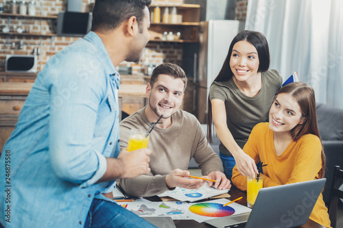 Cheerful four students having talk