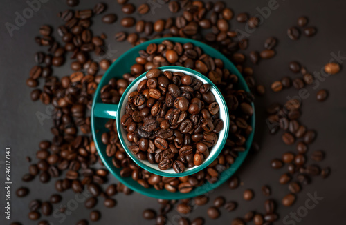 Coffee cup with coffee beans on a stone background