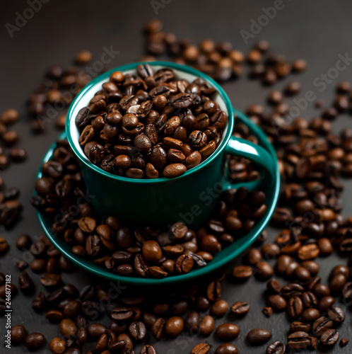 Coffee cup with coffee beans on a stone background