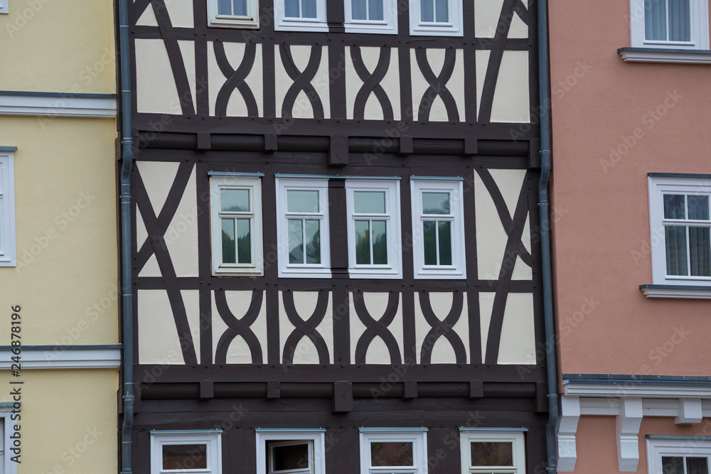 Colorful facades of old half-timbered houses with windows. Europe