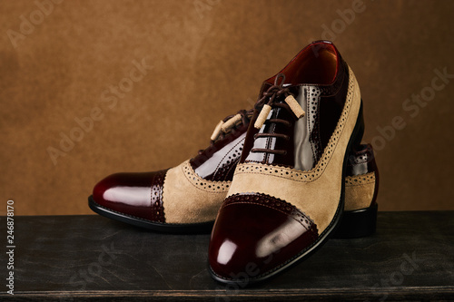 Groom's wedding shoes on a dark wooden box, close-up