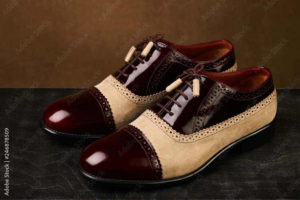 Groom's wedding shoes on a dark wooden box, close-up Groom's wedding shoes on a dark wooden box, close-up