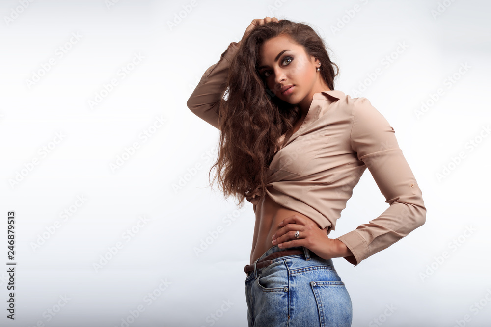 Attractive woman with flat belly and shaped abdominal. Sporty girl posing  on the camera in studio. Sexy model with pretty body and face. Stock Photo  | Adobe Stock