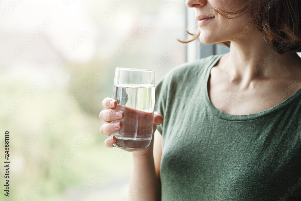 healthy beautiful young woman holding glass of water