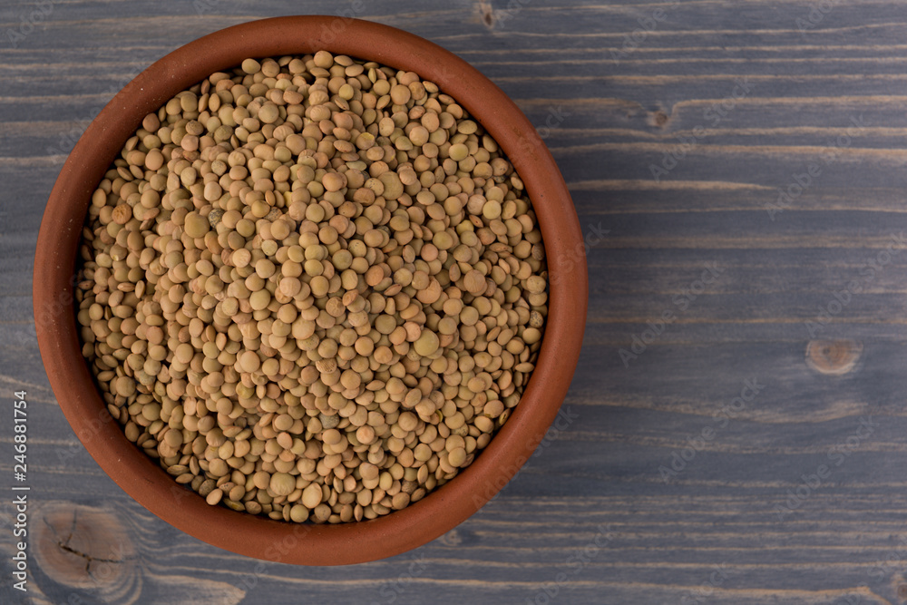 Yellow lentil in a bowl on wooden background Yellow lentil in a bowl on wooden background