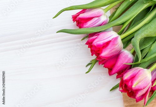 Fototapeta Naklejka Na Ścianę i Meble -  Red tulips on white wooden background. Copy space.