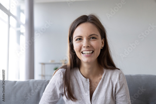 Smiling teen girl speaking by video call distance job interview looking at camera talking to webcam, female vlogger recording vlog at home, teacher student teach study online, head shot portrait