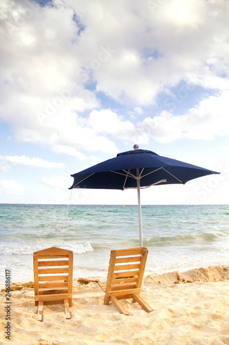 Chairs and umbrella at the beach © Guajillo studio