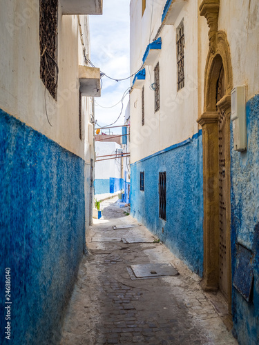 Small cozy streets in blue and white on a sunny day in the old city (medina) Kasbah of the Udayas. UNESCO heritage site. Rabat, Morocco