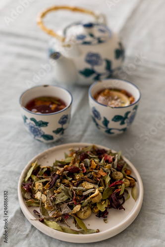 Spring detox concept. Herbal tea in a ceramic tableware and tea cups