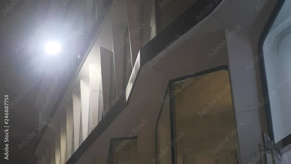 A close up view of office windows on a snowy night. A close up view of office windows on a snowy night.