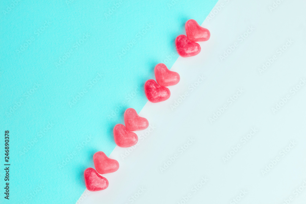 Concept made of heart shaped pink jelly sweets on blue and white background. Top view. Copy space. Valentine's Day. Top view. Copy space. Concept made of heart shaped pink jelly sweets on blue and white background. Top view. Copy space. Valentine's Day. Top view. Copy space.