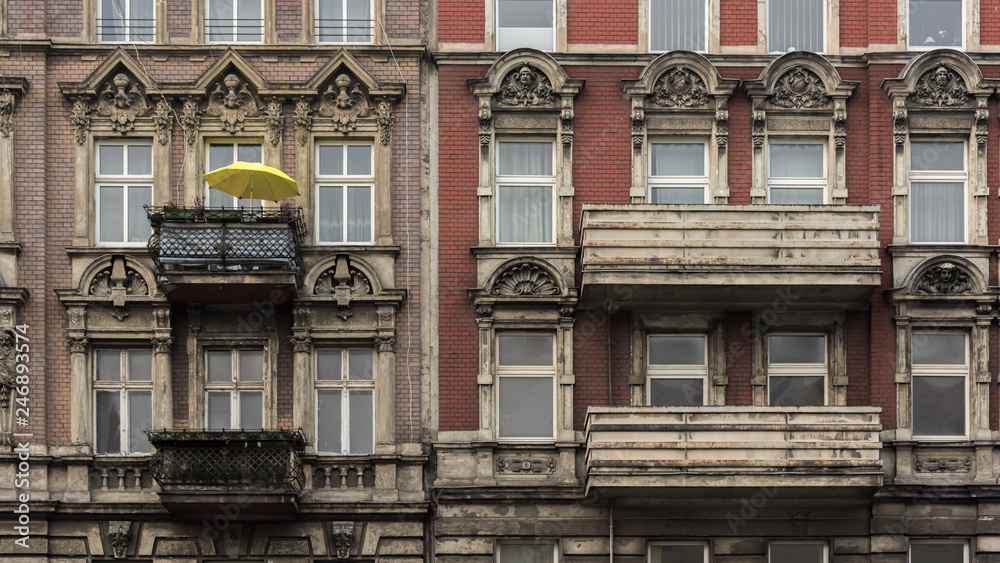 The yellow parasol on the balcony of the old house